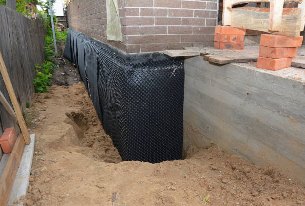 SJ Waterproofing Pros technician performing targeted Basement Waterproofing assessment in Big Rapids, MI